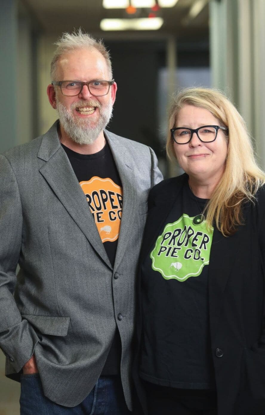 The two owners of Proper Pie Co. wearing branded shirts.